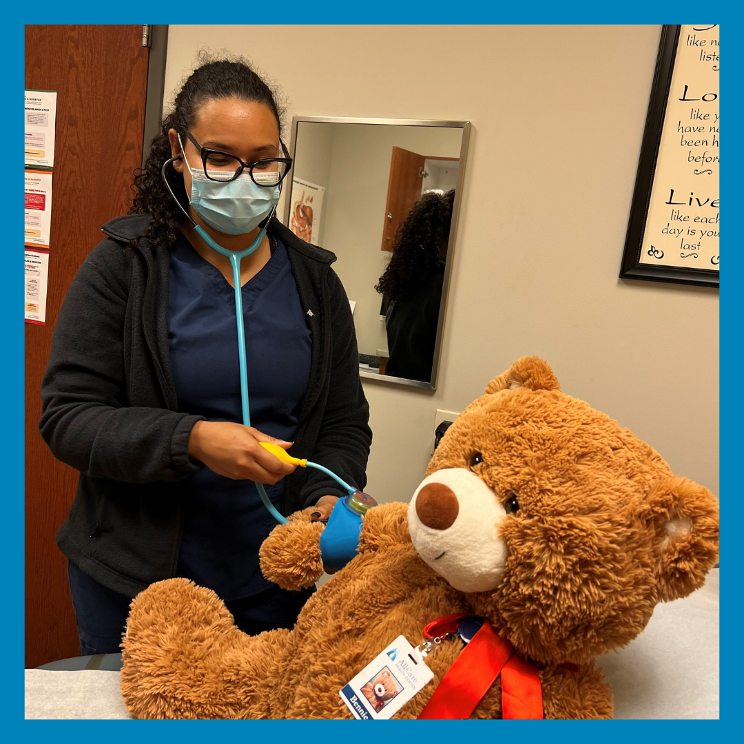 Bennie the bear having his blood pressure taking during their visit during National Teddy Bear Day.