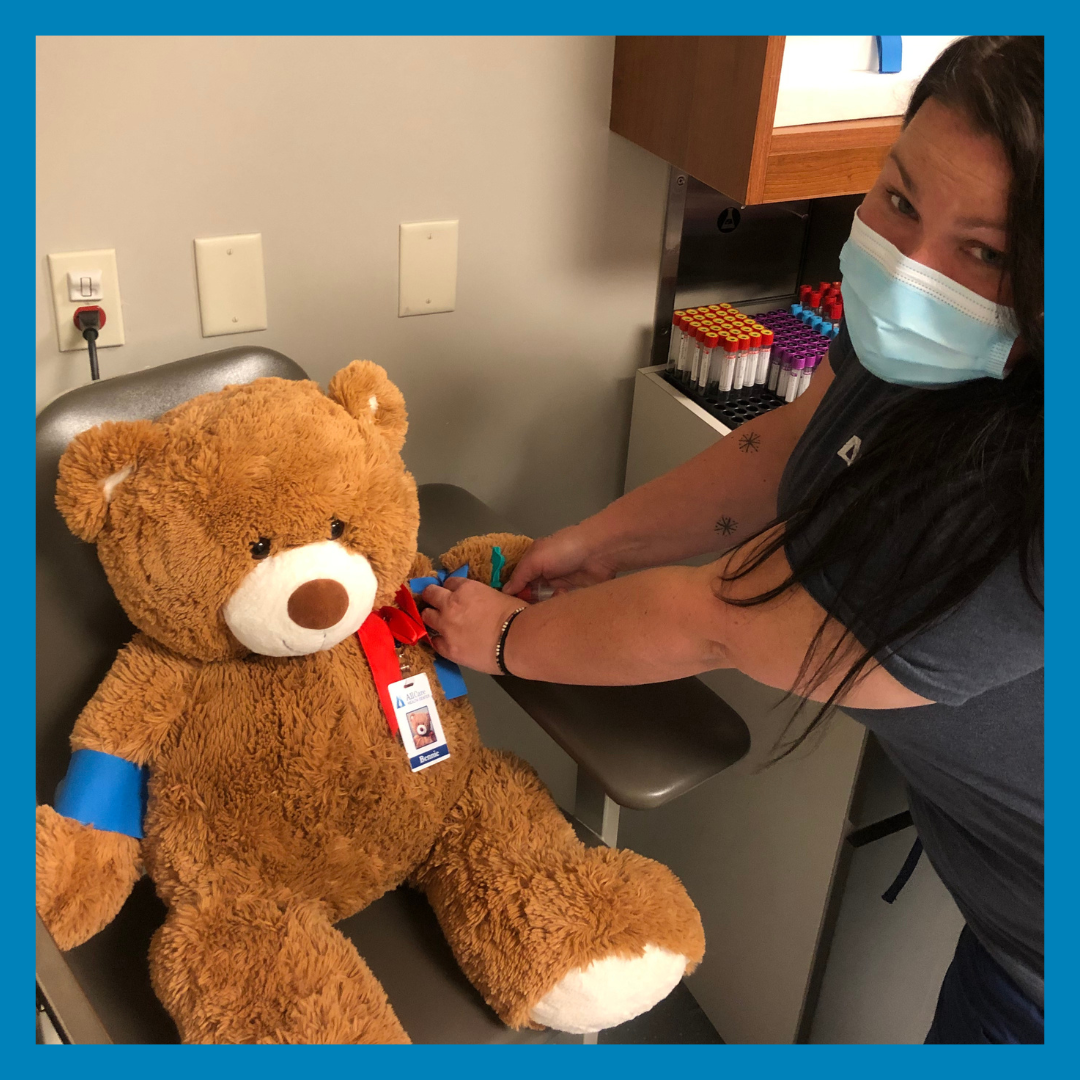 Bennie the bear having lab work done during their visit during National Teddy Bear Day.